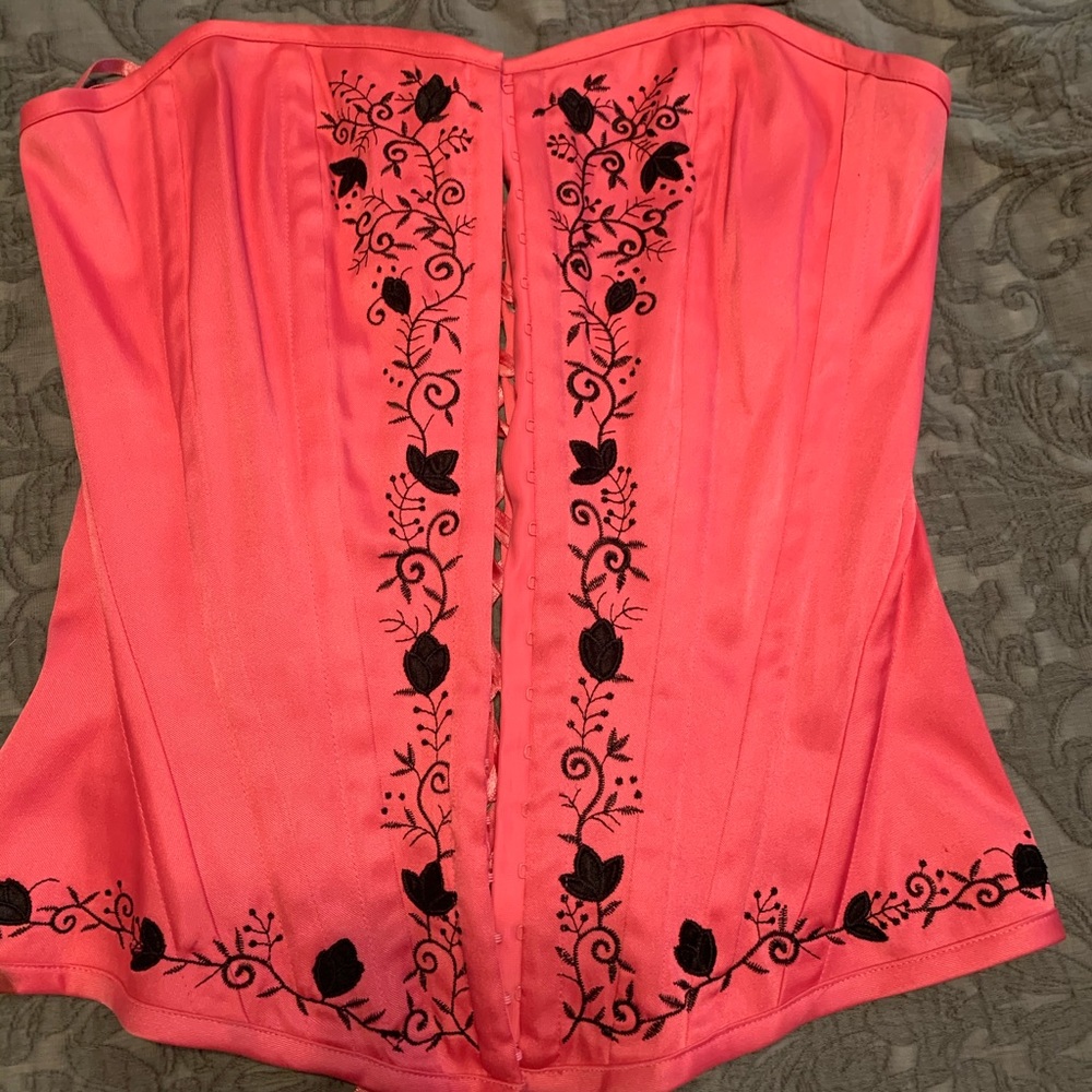 Pink and black laced up corset.